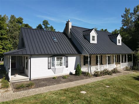 brick house with metal roof picture|white house black metal roof.